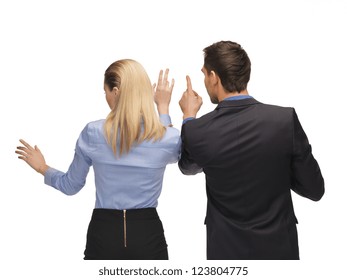picture of man and woman working with something imaginary.