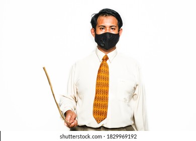 A Picture Of Men Dress Up Like Asian Discipline Teacher Wearing Face Mask With Cane Insight. Reminding People Follow Covid-19 In School And Public Area.