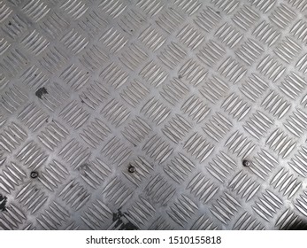 Picture of a metal sheet that has a pattern on the bus