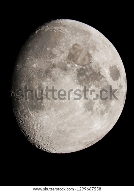 Picture of the moon surface taken with\
telescope, with the moon illuminated at 85\
percent