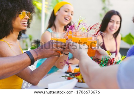 Picture of multiracial group of friends toasting with cocktails - concept of friendship, celebration and vacation
