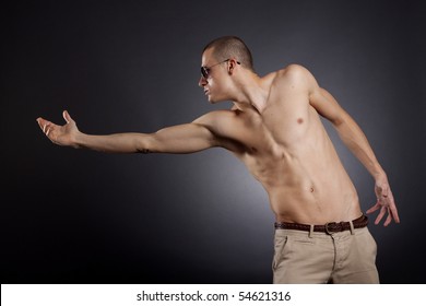 Picture Of A Muscular Man With Sunglasses Reaching Out