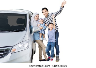 Picture Of Muslim Family Standing Near Their Car While Waving Hands At The Camera, Isolated On White Background