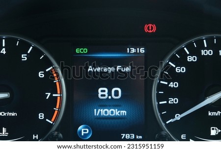 A picture with noise effect of car dashboard with information of average fuel consumption for a car. and eco mode on