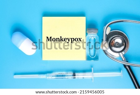 A picture of notepad written monkeypox, stethoscope ,medicine and vaccine. Monkeypox is virus transmitted to humans from animals with symptoms very similar to smallpox.