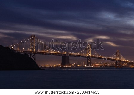 A picture of the Oakland Bay Bridge as seen from Treasure Island at night.