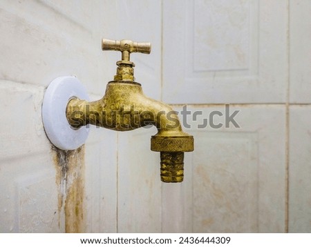 A picture of old brass faucet. Bronze metelic water tab
