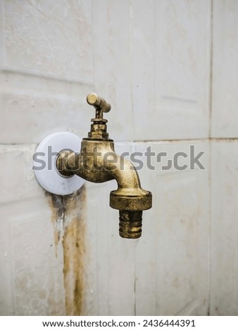 A picture of old brass faucet. Bronze metelic water tab