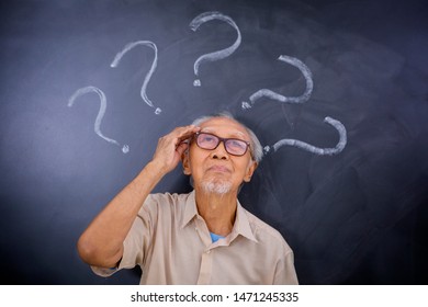 Picture Of Old Man Scratching His Head While Thinking An Idea Under Question Marks