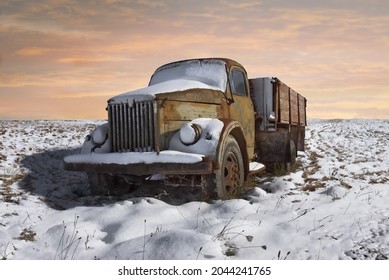 A Picture Of The Old And Rusty Soviet Truck Covered With Snow