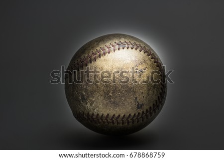 picture of old softball on black background