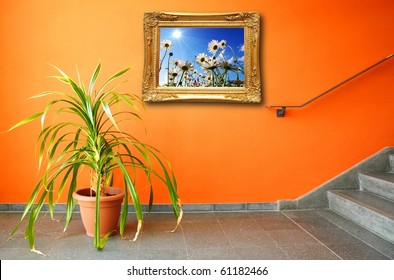 picture on a wall and plant showing interior concept