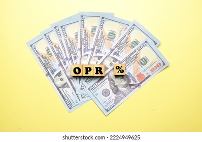 A Picture Of OPR % Or Overnight Policy Rate On Wooden Block And Fake Money. 