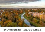 A picture of the Ostravice river and the foliage in the fall at sunset.