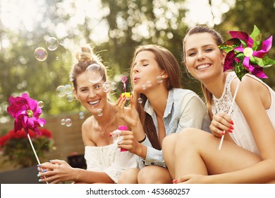 Picture Presenting Happy Group Of Friends Sitting Outdoors