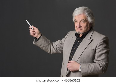 Picture Of Professor Man Of University Or College Having Lecture In Studio. Experienced Teacher Explaining Material To Students Or Pupils.