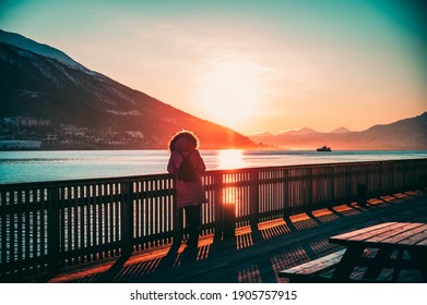 A Picture Of Random Girl Standing Watching Sunrise At The Deck