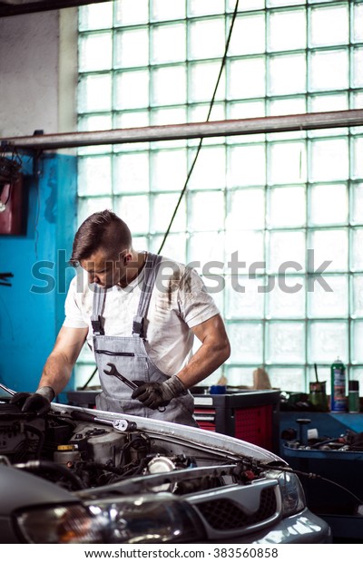 Picture of\
repairman laboring in professional\
workshop