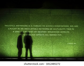 Picture Of A Reverend Martin Luther King Jr. Memorial Quote In Washington, DC At Night In July 2016 With The Shadows Of Two People.