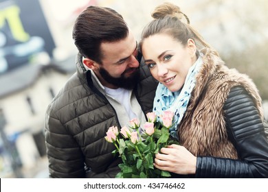 Picture of romantic couple on date with flowers