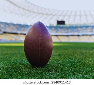 A picture of rugby players with a rugby ball, men playing, a stadium with rugby field, cheering fans, and lush green turf. - Powered by Shutterstock