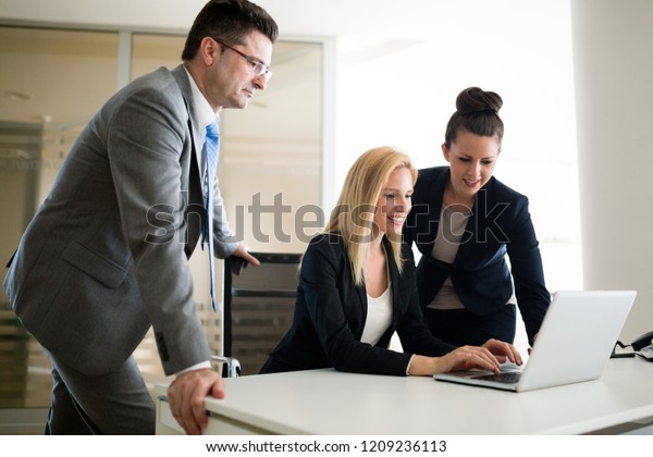 Picture of\
sales agents working together in\
office