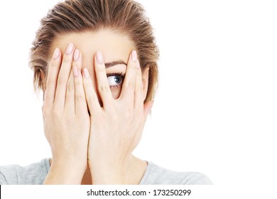 A picture of a scared woman covering her eyes over white background