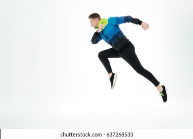 Picture of serious strong sportsman running isolated over white background. Looking aside. - Shutterstock ID 637268533