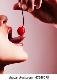 Picture Of Sexy Tongue Tasting A Red Cherry