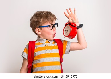 Picture Of Shocked Little Boy Holding Clock Alarm. Set Up Alarm Clock. Child Hold Red Clock. It Is Never Too Late. Define Your Own Rhythm Of Life. Happy Hours Concept. Schedule And Timing