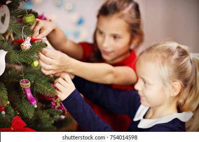 Picture showing children decorating Christmas tree Stock Photo