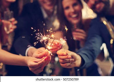Picture showing group of friends having fun with sparklers - Shutterstock ID 507250789