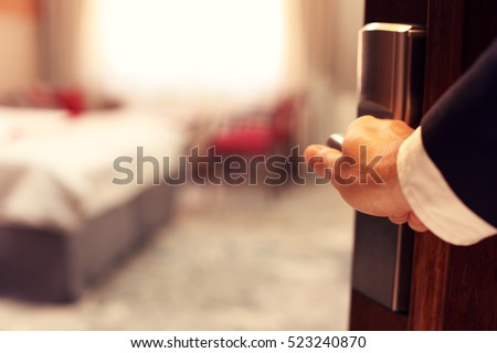 Picture showing hand of businessman opening hotel room