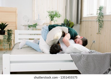 Picture Showing Happy Gay Couple Having Pillow Fight