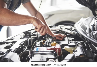 Picture showing muscular car service worker repairing vehicle. - Shutterstock ID 744678226