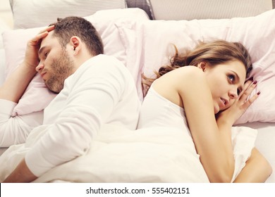 Picture Showing Unhappy Couple Argueing In Bed