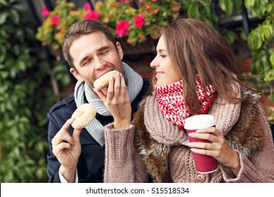 Picture Showing Young Couple On Date In The City With Coffee And Donuts