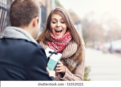 Picture Showing Young Couple With Present In The Park