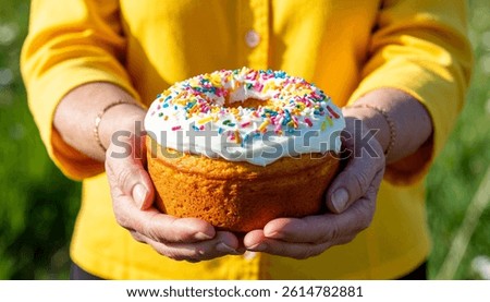 The picture shows hands holding an Easter cupcake. Happy Easter, holiday.