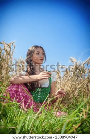 Similar – Foto Bild Frau im Dirndl im bayerischen Biergarten sitzend und Bier trinkend mit traditioneller bayerischer Küche mit Schweinshaxe, gebratener Schweinshaxe auf einem Tisch