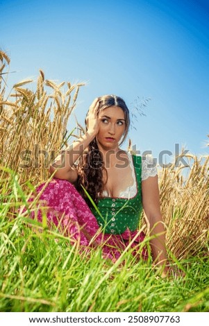 Similar – Foto Bild Frau im Dirndl im bayerischen Biergarten sitzend und Bier trinkend mit traditioneller bayerischer Küche mit Schweinshaxe, gebratener Schweinshaxe auf einem Tisch