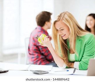 Picture Of Smiling Student Girl Eating Apple At School