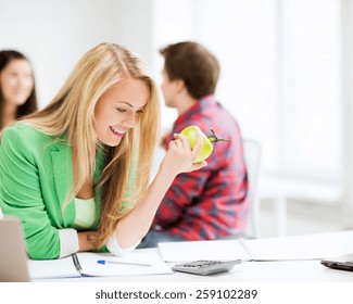 Picture Of Smiling Student Girl Eating Apple At School