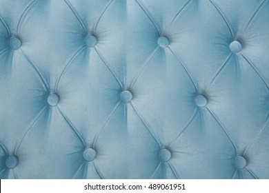 Picture of sofa texture background. Closeup picture of dark blue leather texture background with buttoned pattern.
