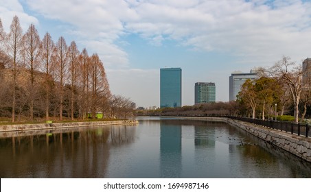 A Picture Of Some Buildings Of The Osaka Business Park Reflected On The Moat Around The Osaka Castle.