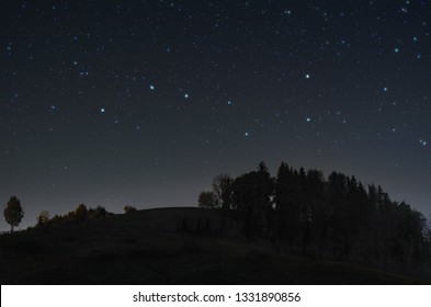 A picture of the starry night sky with Ursa Major constellation over the hill