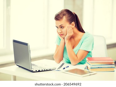 Picture Of Stressed Student With Computer At Home