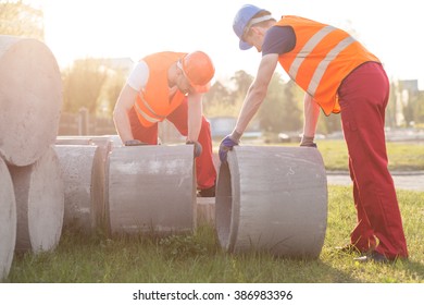 Picture Of Strong Builders With Concrete Tubes