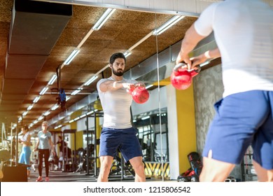 Picture Of Strong Focused Sporty Man Lifting Weight In Gym. Standing In Front Of The Mirror.