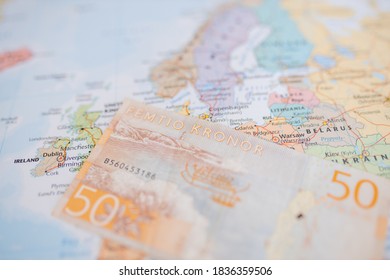 Picture of Sweden on a blurry European Map with a 50 Swedish Kronor Banknote (with the words Fifty Kronor in Swedish) on Top